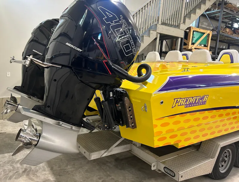 Slide: The Image of Yellow Predator C30 powerboat with dual Mercury 400R engines on a trailer, indoors. - 5