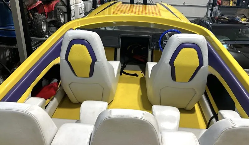 Slide: The Image of Interior of a 2018 Predator C30 boat with yellow and purple seating. - 9