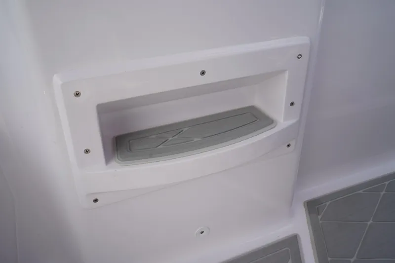 Slide: The Image of Storage compartment on 2022 Axopar 22 T-Top boat, featuring sleek design and secure fastening. - 10