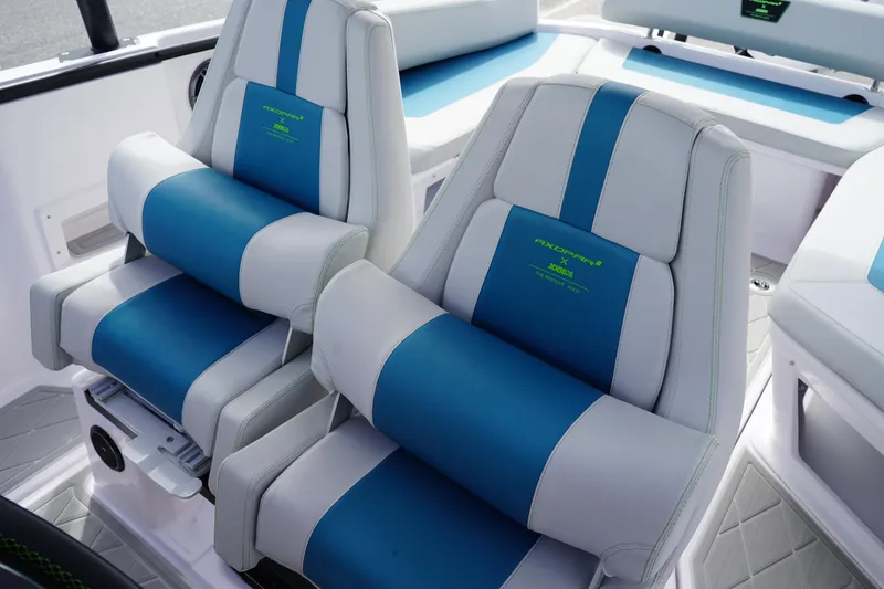 Slide: The Image of 2022 Axopar 22 T-Top boat seats, blue and white upholstery, modern design. - 13
