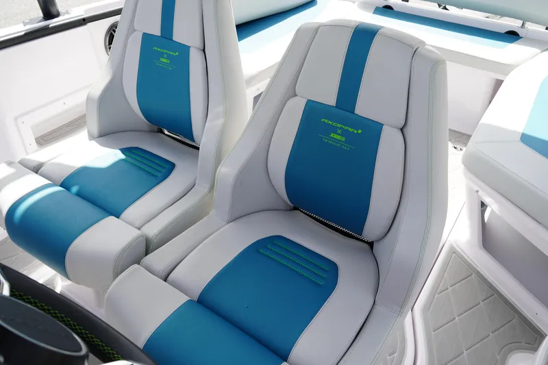 Slide: The Image of 2022 Axopar 22 T-Top boat seats, featuring blue and white upholstery with green accents. - 14