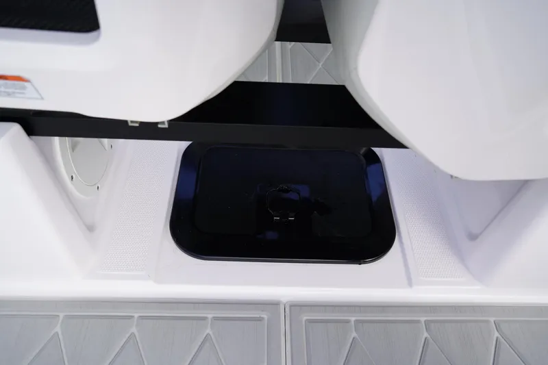 Slide: The Image of 2022 Axopar 22 T-Top boat interior detail with storage compartment. - 21