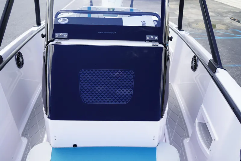 Slide: The Image of 2022 Axopar 22 T-Top boat interior with blue and white seating and modern design. - 23