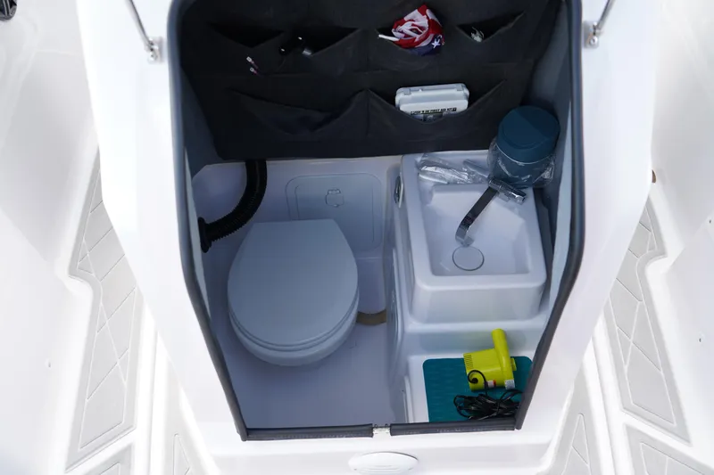 Slide: The Image of 2022 Axopar 22 T-Top boat interior with toilet and sink. - 25