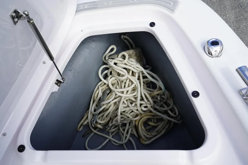 Slide: The Image of Anchor storage compartment with rope on 2022 Axopar 22 T-Top boat. - 28