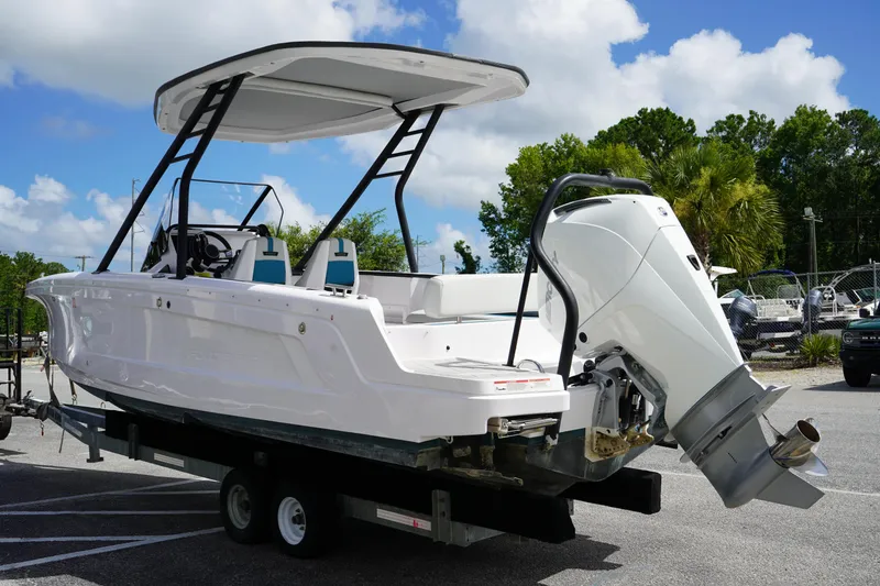 Slide: The Image of 2022 Axopar 22 T-Top boat on trailer, featuring sleek design and powerful outboard motor. - 4