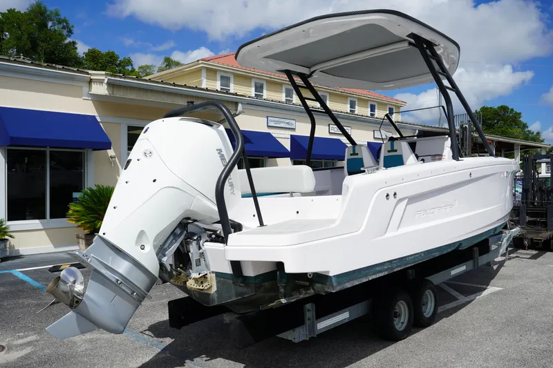Slide: The Image of 2022 Axopar 22 T-Top boat with Mercury engine on trailer, parked outdoors. - 5