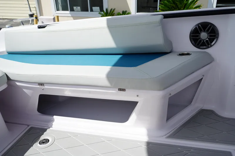 Slide: The Image of 2022 Axopar 22 T-Top boat interior with cushioned seating and speaker. - 9