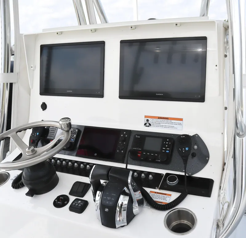 Slide: The Image of 2022 Contender 35 ST boat dashboard with dual Garmin screens and control panel. - 10