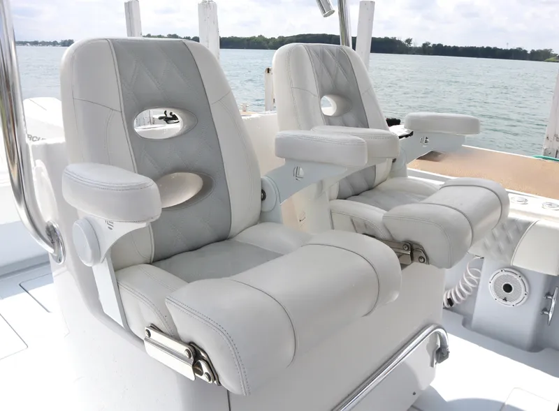 Slide: The Image of Luxury seating on 2022 Contender 35 ST boat, featuring plush white upholstery and armrests. - 11