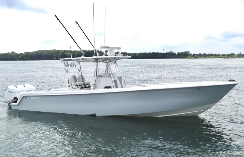 Slide: The Image of 2022 Contender 35 ST boat on calm water, featuring sleek design and fishing equipment. - 4