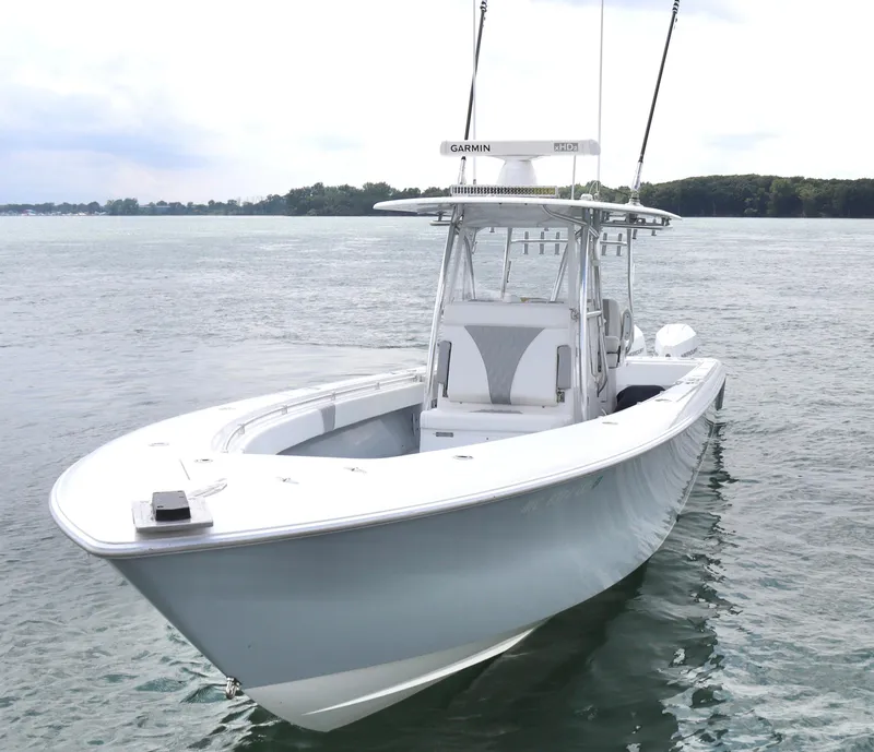 Slide: The Image of 2022 Contender 35 ST boat on calm water, featuring sleek design and advanced Garmin technology. - 5