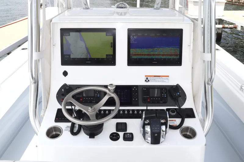 Slide: The Image of Center console of 2022 Contender 35 ST boat with navigation screens and controls. - 7
