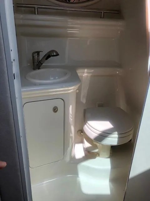 Slide: The Image of Compact bathroom in 2008 Sea Ray 260 Sundancer boat, featuring sink and toilet. - 13