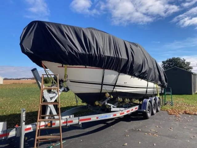 Slide: The Image of 2008 Sea Ray 260 Sundancer boat covered on trailer, parked outdoors under blue sky. - 3