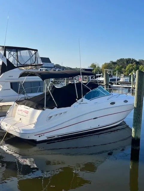 Slide: The Image of 2008 Sea Ray 260 Sundancer boat docked at marina under clear blue sky. - 4