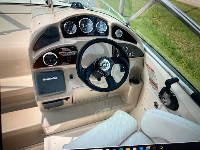 Slide: The Image of 2008 Sea Ray 260 Sundancer dashboard with steering wheel and gauges. - 6