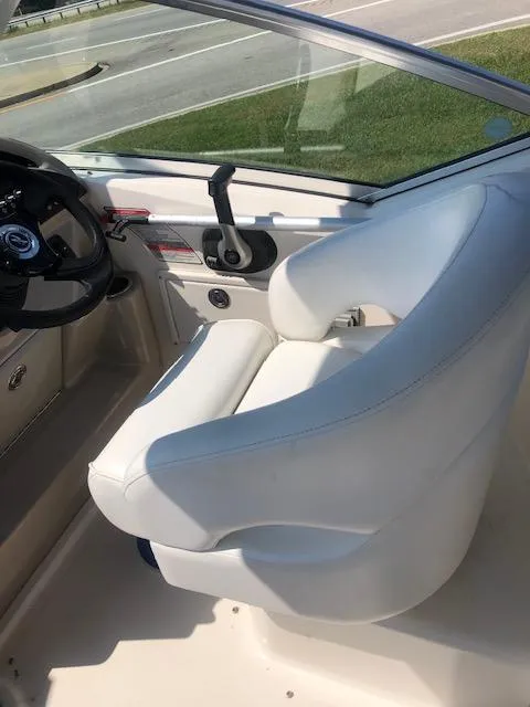 Slide: The Image of 2008 Sea Ray 260 Sundancer cockpit with white captain's chair and steering wheel. - 7