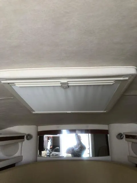 Slide: The Image of Interior cabin view of a 2008 Sea Ray 260 Sundancer boat, featuring a ceiling hatch. - 8
