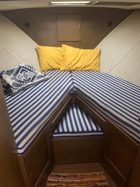 Slide: The Image of Cozy cabin interior of 1965 Chris-Craft 460 Constellation with striped bedding and yellow pillows. - 10