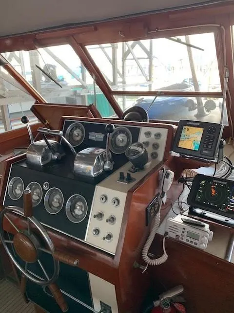Slide: The Image of Helm of 1965 Chris-Craft 460 Constellation with vintage controls and modern navigation equipment. - 5