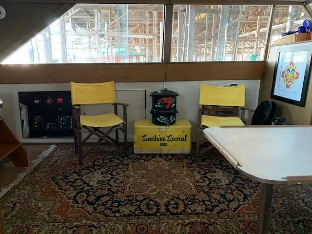 Slide: The Image of 1965 Chris-Craft 460 Constellation interior with yellow chairs, vintage decor, and patterned rug. - 6