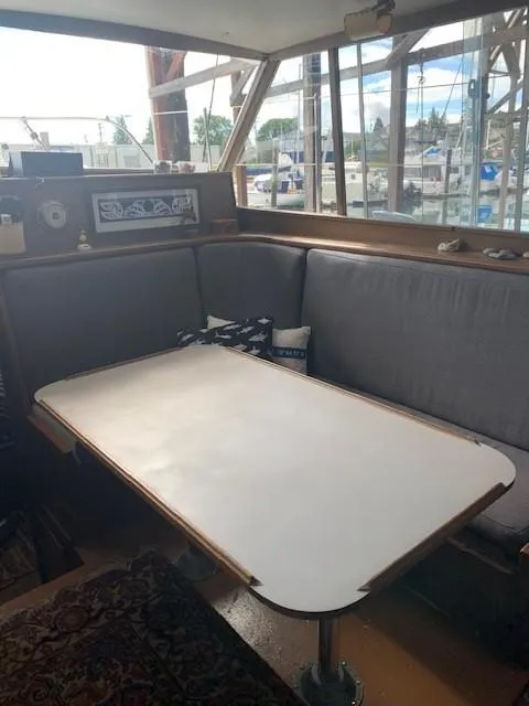 Slide: The Image of 1965 Chris-Craft 460 Constellation interior with dining area and large windows. - 8