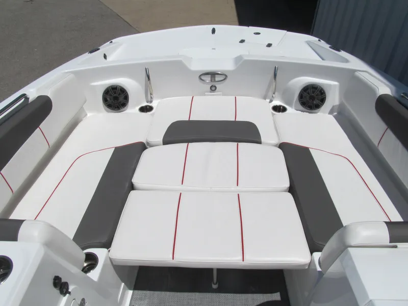 Slide: The Image of 2023 Tahoe 2150 boat interior with white and gray seating, red accents, and speakers. - 11