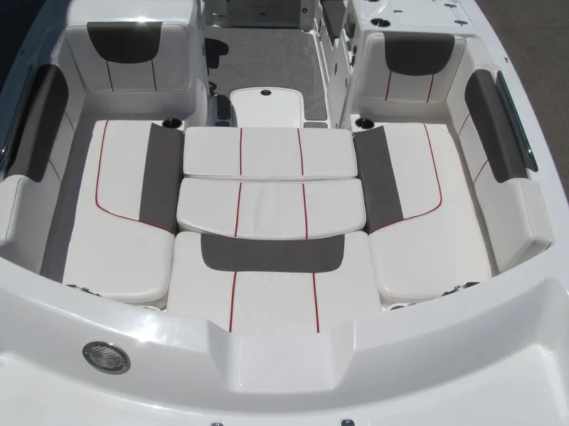 Slide: The Image of 2023 Tahoe 2150 boat interior with white and gray seating, red accents. - 12