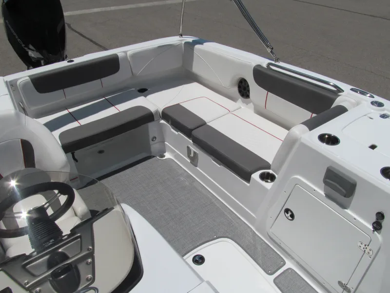 Slide: The Image of 2023 Tahoe 2150 boat interior with gray seating and modern dashboard design. - 14