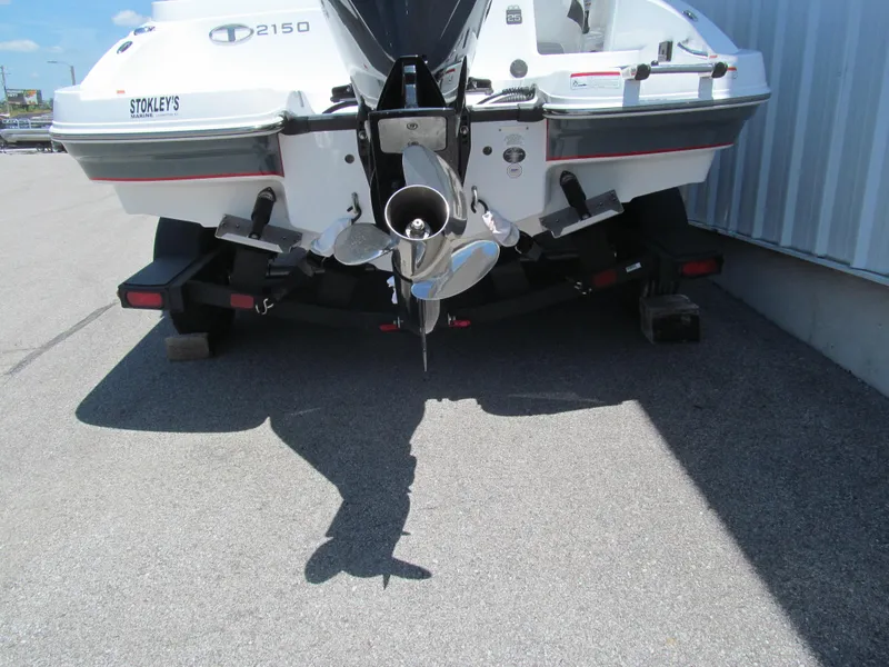 Slide: The Image of 2023 Tahoe 2150 boat on trailer, rear view showing propeller and outboard motor. - 5