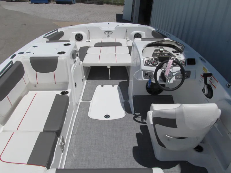 Slide: The Image of 2023 Tahoe 2150 boat interior with modern seating and steering console. - 6