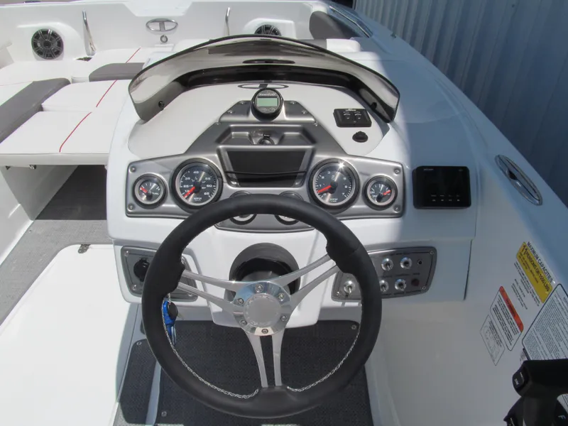 Slide: The Image of 2023 Tahoe 2150 boat dashboard with steering wheel and instrument panel. - 7