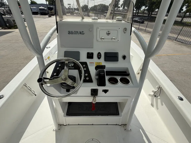 Slide: The Image of 2018 BlackJack 256 boat console with steering wheel and Simrad electronics. - 10