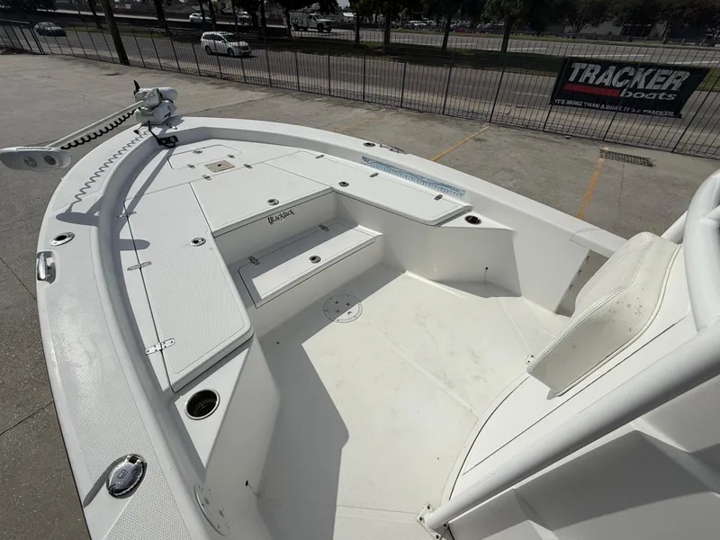 Slide: The Image of 2018 BlackJack 256 boat deck with seating and storage compartments. - 11