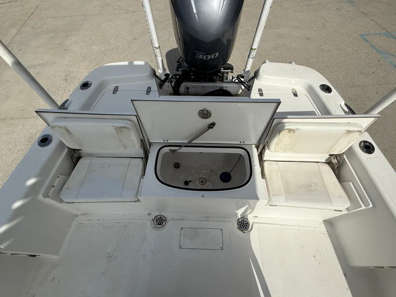 Slide: The Image of 2018 BlackJack 256 boat deck with open storage compartments and Yamaha 300 engine. - 14