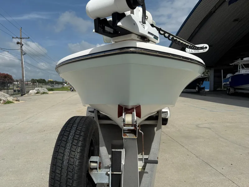 Slide: The Image of Front view of a 2018 BlackJack 256 boat on a trailer, outdoors under a blue sky. - 3