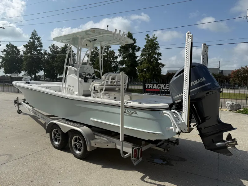 Slide: The Image of 2018 BlackJack 256 boat on trailer with Yamaha outboard motor, parked outdoors. - 5