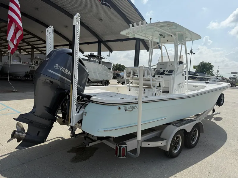 Slide: The Image of 2018 BlackJack 256 boat with Yamaha engine on trailer, parked at a marina. - 7
