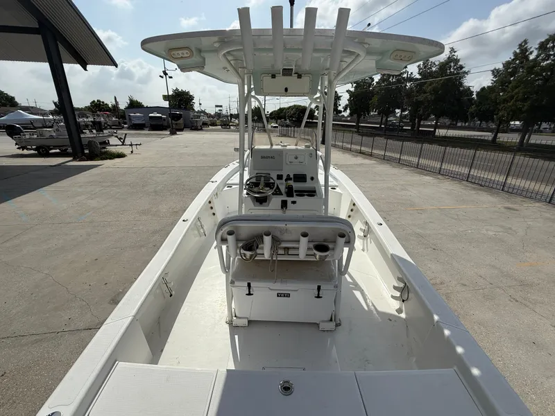 Slide: The Image of 2018 BlackJack 256 boat with center console, parked outdoors on a sunny day. - 8