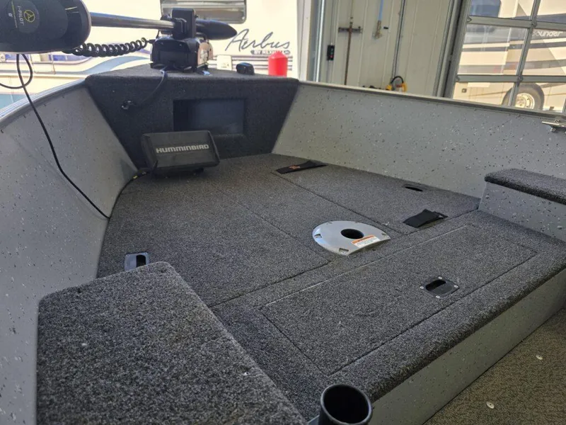 Slide: The Image of 2020 Lund 1600 Fury Tiller boat interior with Humminbird fish finder and carpeted deck. - 12