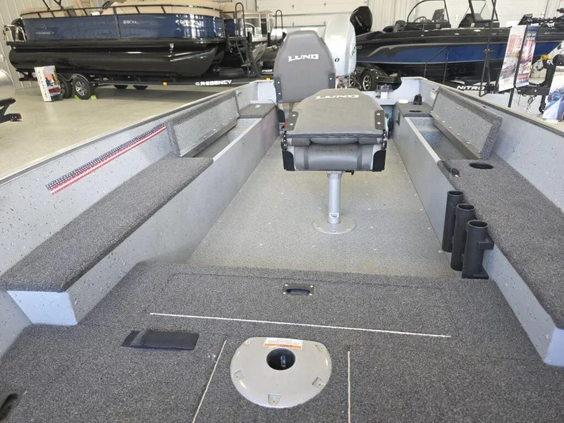 Slide: The Image of 2020 Lund 1600 Fury Tiller boat interior with seating and storage compartments. - 13