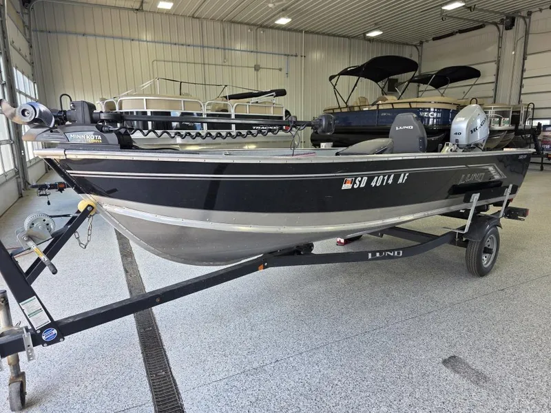 Slide: The Image of 2020 Lund 1600 Fury Tiller boat on trailer in indoor showroom. - 3