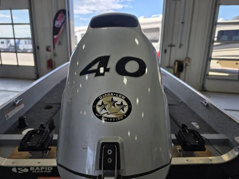 Slide: The Image of 2020 Lund 1600 Fury Tiller boat with 40 HP engine in a garage setting. - 6