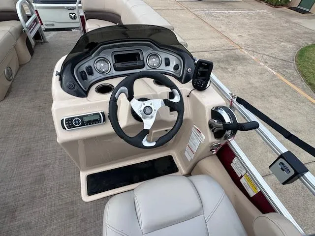 Slide: The Image of 2019 Sun Tracker SportFish 22 DLX boat dashboard with steering wheel and controls. - 9