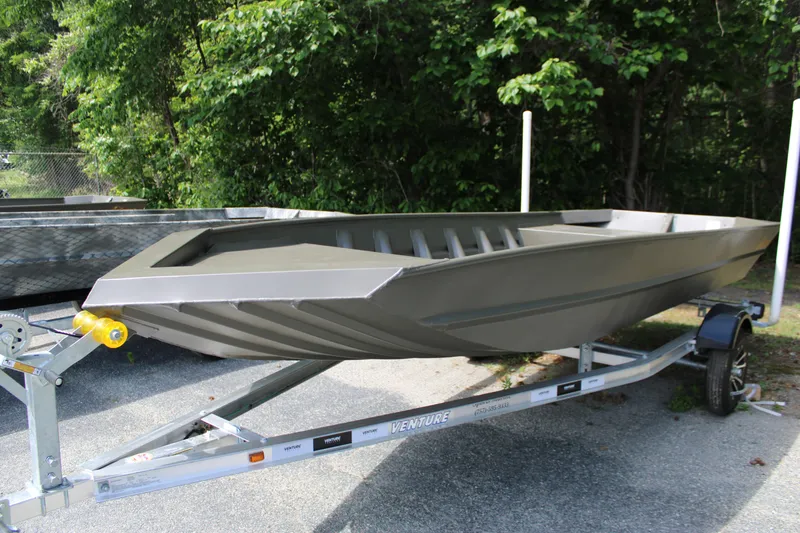 Slide: The Image of 2025 WeldBilt 1652V boat on trailer, parked outdoors with lush greenery background. - 3