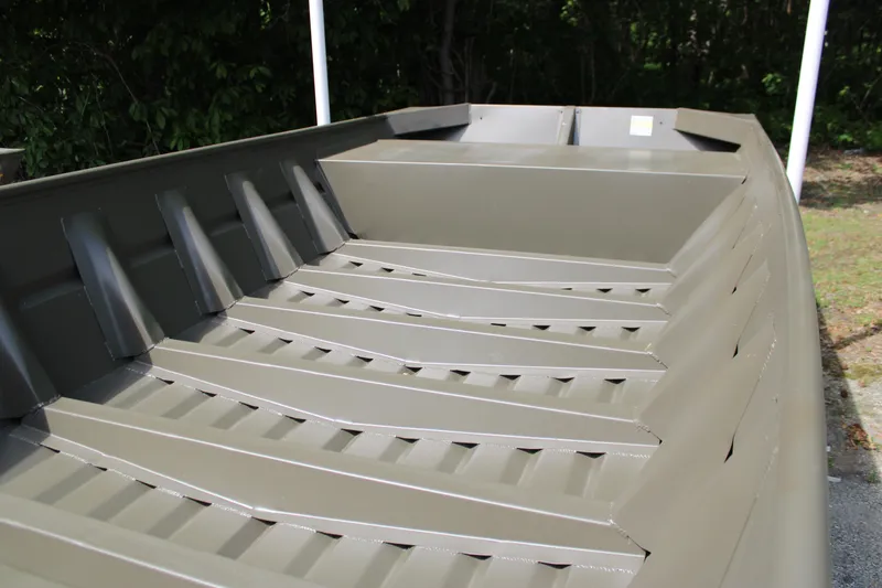 Slide: The Image of 2025 WeldBilt 1652V boat interior, showcasing durable metal construction and ribbed flooring. - 4
