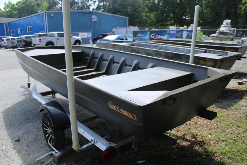 Slide: The Image of 2025 WeldBilt 1652V boat on trailer, parked outdoors near blue building. - 5