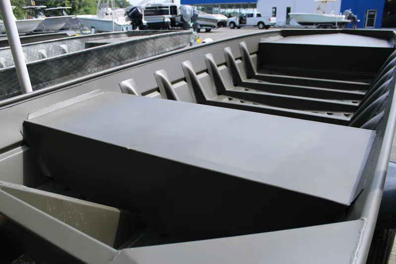 Slide: The Image of 2025 WeldBilt 1652V aluminum boat interior with bench seats, displayed outdoors. - 8