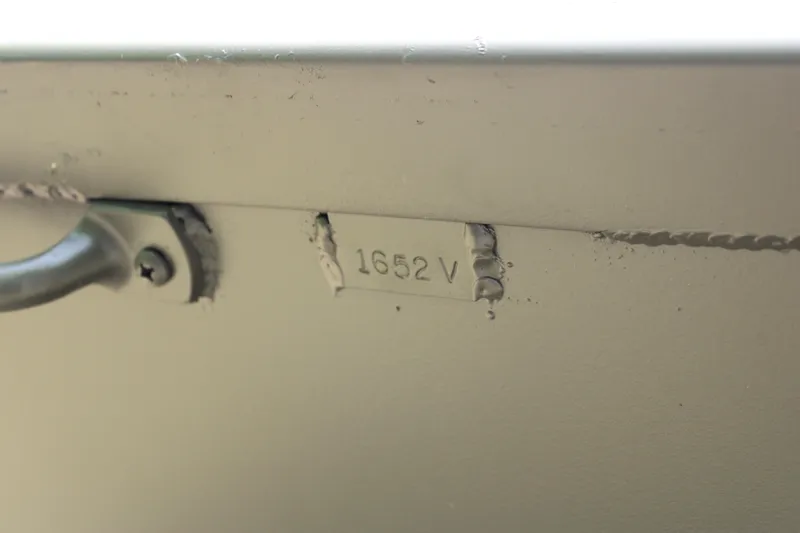 Slide: The Image of Close-up of WeldBilt 1652V boat model number, 2025, with visible welds and handle. - 9